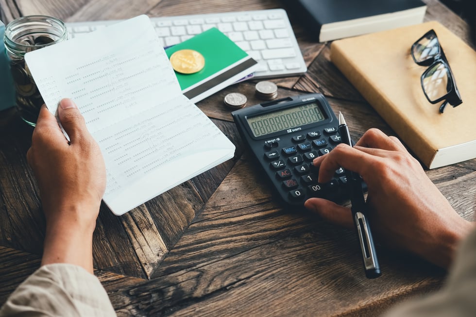 Top View of Person Using Calculator